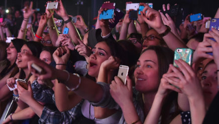 Concertgoers use their cellphones during a Fifth Harmony concert March 23, 2015, in New York. The company Yondr created a locking pouch to hold phones during performances, creating a "phone-free zone."